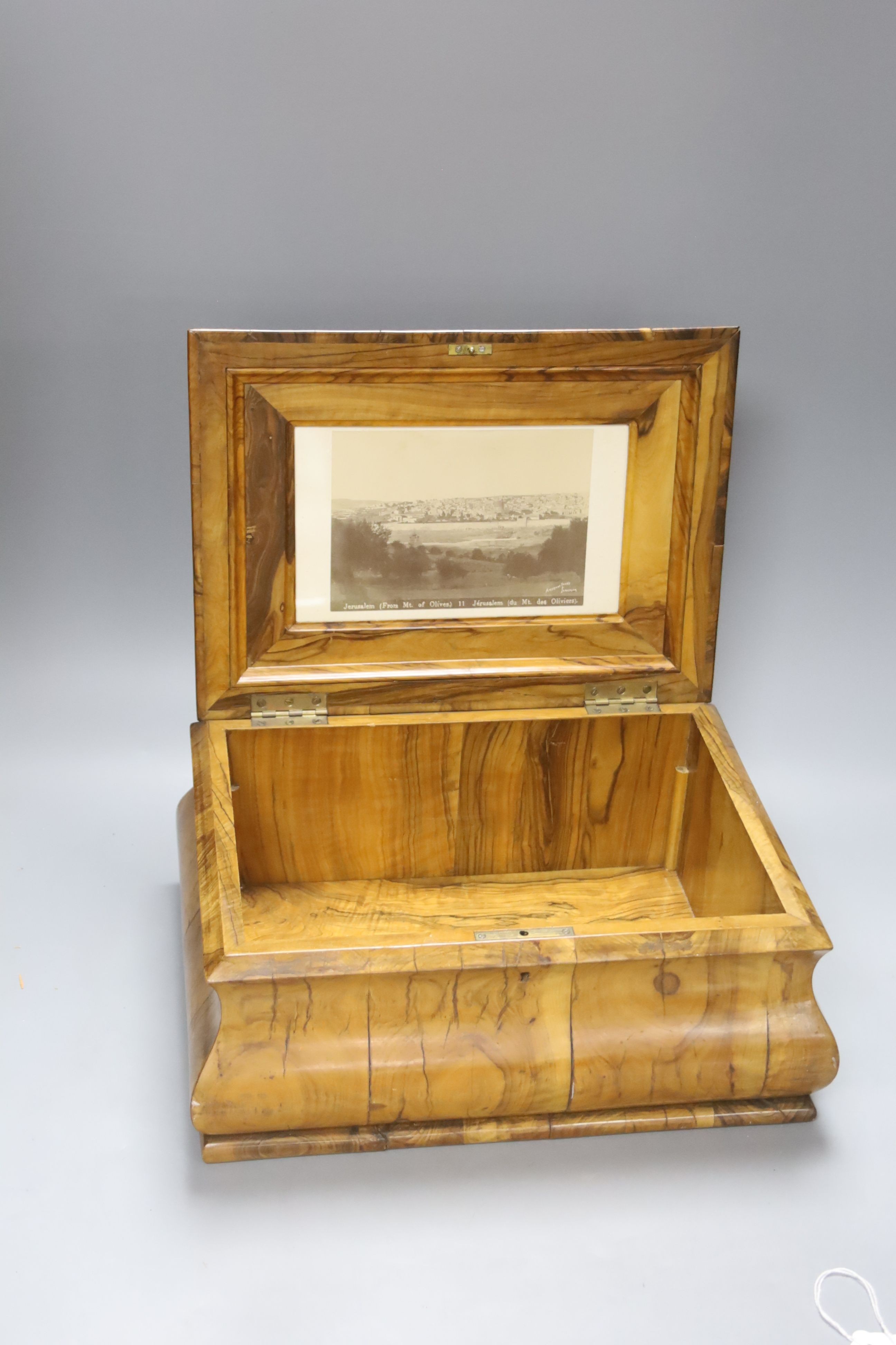 A Jerusalem olivewood casket, bombe shape with inset photograph, width 34cm